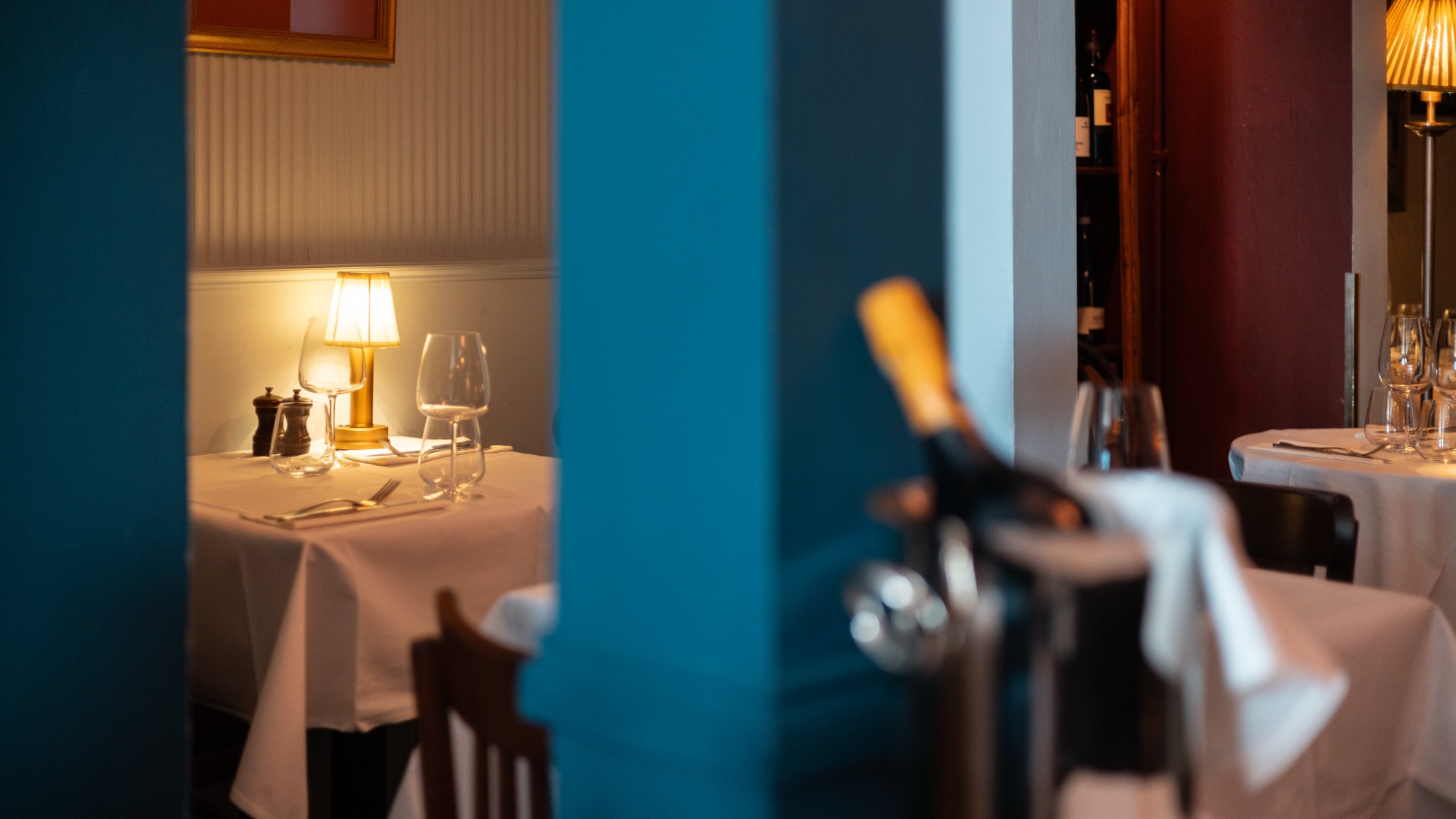 Candlelit table through blue columns at Soleto Italian restaurant
